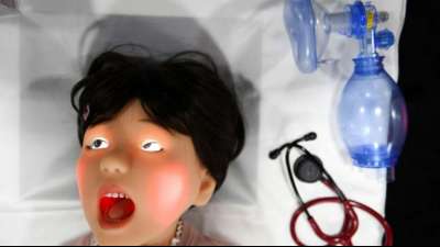 Menschliche Mimik: Kinderpuppen und graugesichtige Roboter