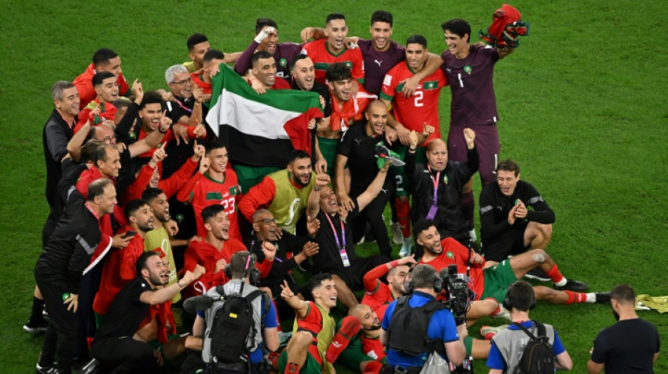 Morocco players celebrate with Palestinian flag after Spain upset