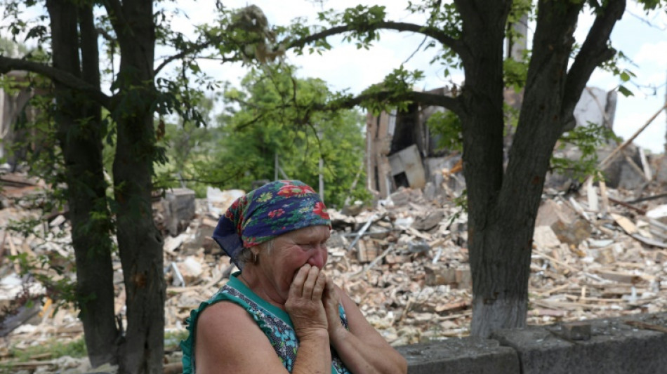 Ukraine's Zelensky visits war-torn southern city as battles rage