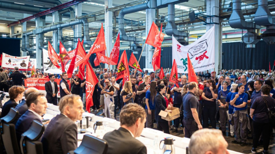 VW bosses defend possible plant closures at stormy meeting