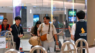 Relieved travellers land in Singapore after deadly turbulence