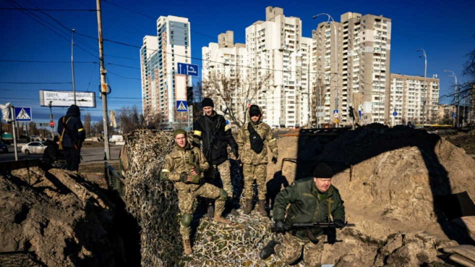 Russia strikes Ukrainian cities as convoy masses near capital