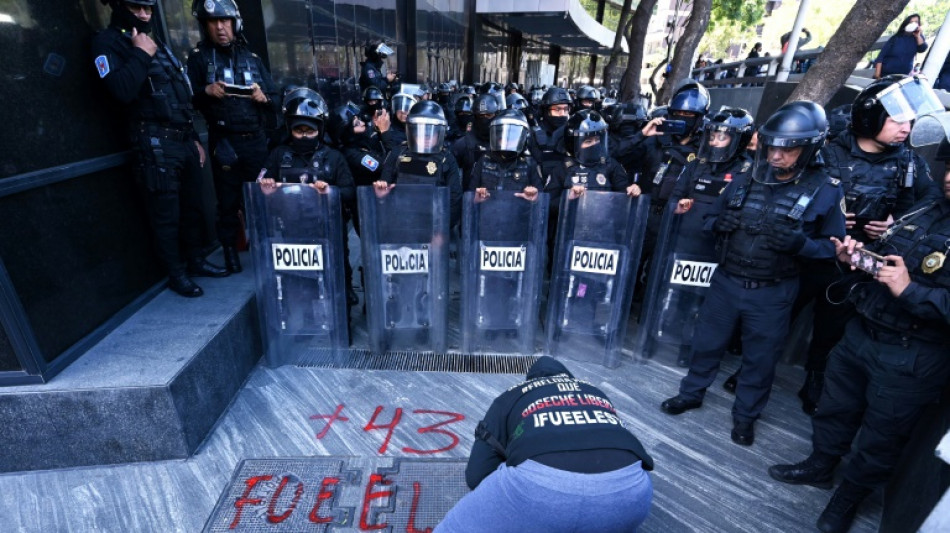 11 police hurt at Mexico protest over missing students