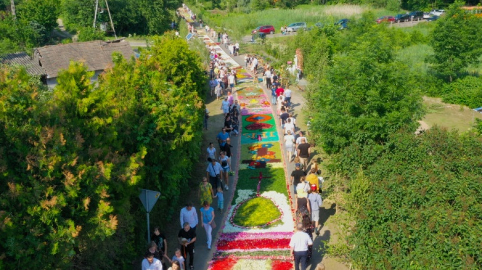 Poles carpet streets with flowers for Corpus Christi